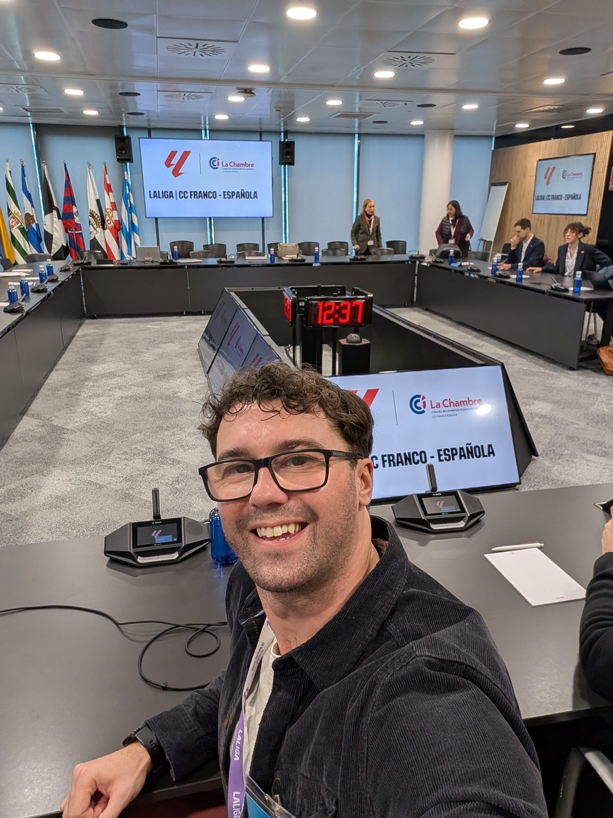 A selfie at a boardroom table in front of a screen reading LALIGA | CC Franco-Española
